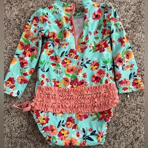 Rufflebutts girls swimsuit. Long sleeves with 3 snap bottom closure. Size 2T.